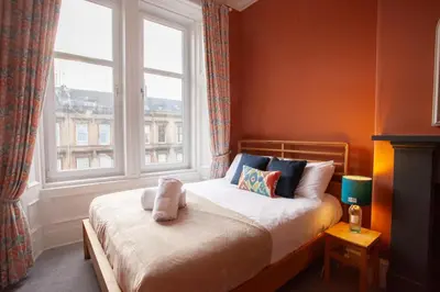 a bedroom with a bed in front of a window at Newly Renovated Flat in Trendy Finnieston in Glasgow