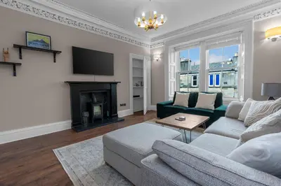 a living room with a couch and a fireplace at GuestReady - Charming home in Edinburgh in Edinburgh