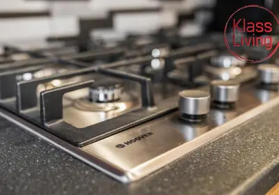 a close up of a stove top with the words kiss living at Oxford Apartment by Klass Living in Coatbridge