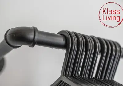 a close up of a black metal bench with a logo at Oxford Apartment by Klass Living in Coatbridge