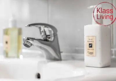 a bathroom sink with a faucet and a cup on a counter at Oxford Apartment by Klass Living in Coatbridge