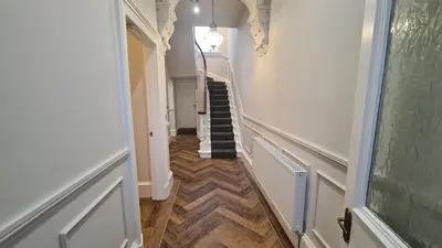 a hallway with a stairway with a stair case at 5 Bedrooms Sleeps 10 Full Kitchen Parking in Ayr