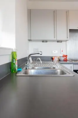 a kitchen sink with a dish rack on it at Argyle Place in Glasgow