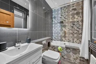 a bathroom with a sink and a toilet and a shower at The Bruadair - Modern Town Living in Ardrossan