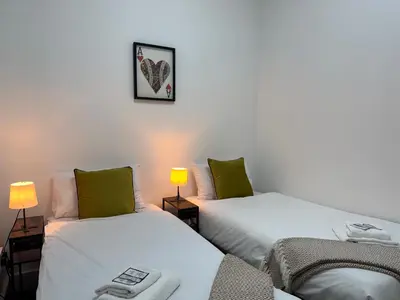 two beds sitting next to each other in a room at Squarezzz - Group Accommodation in Edinburgh
