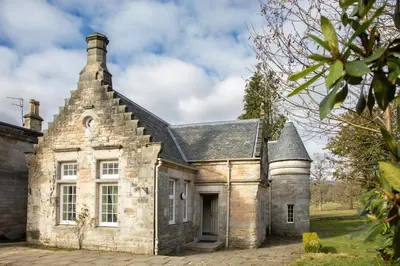 an old stone house with a roof at The Dower House at Solsgirth Home Farm in Dollar