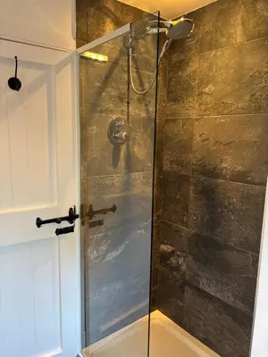 a shower with a glass door in a bathroom at The Loch Lomond But n Ben in Gartocharn