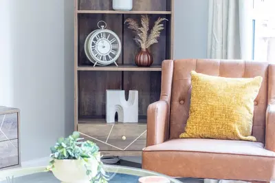 a living room with a chair and a table at Lendrick House-Spacious 3 Bed House in Falkirk in Polmont