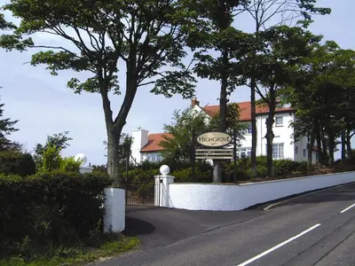 a sign on a road in front of a house at Highgrove House Hotel in Loans