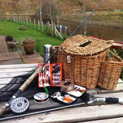 a wooden table with a basket and a baseball bat at Clan Cottages Luxury Thatched Retreat near Oban in Oban