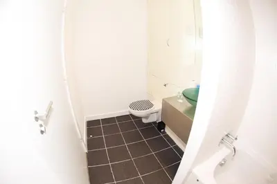 a small bathroom with a toilet and a sink at Glasgow Hydro Apt with Great Views in Glasgow