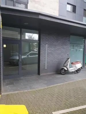 a scooter parked in front of a building at Glasgow Hydro Apt with Great Views in Glasgow