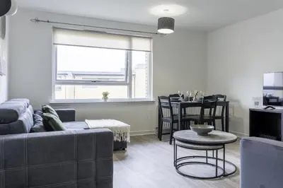 a living room with a couch and a table at Charlotte Apartment in Glasgow