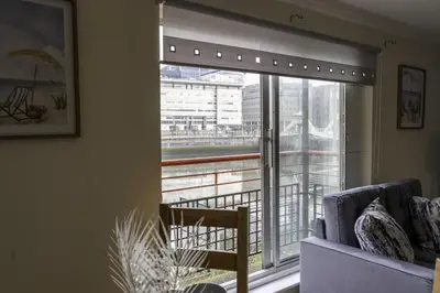 a living room with a window with a blind at Riverview House in Glasgow