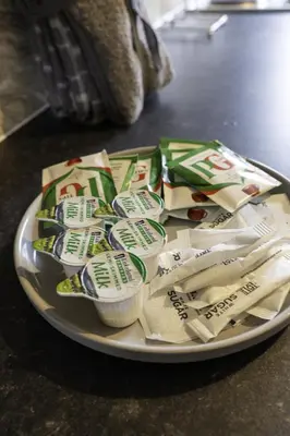 a plate with packets of food on a table at Riverview House in Glasgow