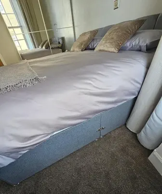 a large bed with white sheets and pillows on it at Ocean View 2 in Campbeltown