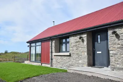 a brick house with a red roof at The Old House, Balure in Oban