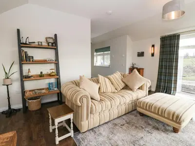 a living room with a couch and a stool at The Old House, Balure in Oban