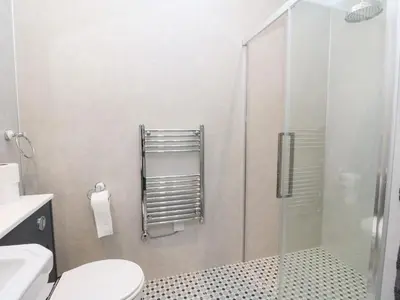 a bathroom with a toilet and a glass shower at The Old House, Balure in Oban