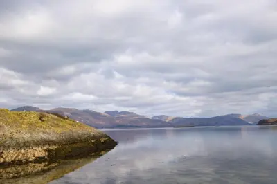 a large body of water with mountains in the background at The Old House, Balure in Oban