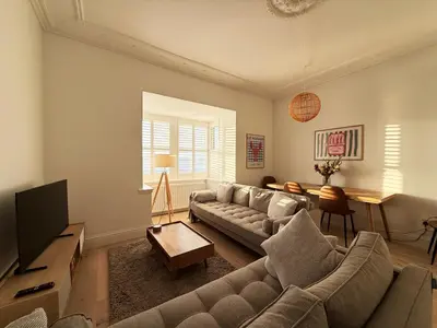 a living room with a couch and a tv at Bay View Cottage in Fairlie