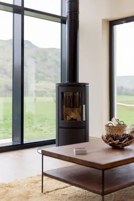 a living room with a fireplace and a coffee table at Holiday Home Balbeg Cottage by Interhome in Straiton