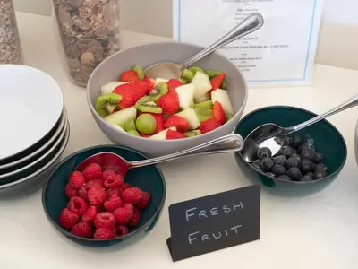 three bowls of fruit on a table with a sign that reads fresh fruit at East Laigh Gree Bed and Breakfast in Burnhouse