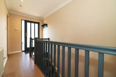 a staircase in a house with a hallway at Signature - Cross House in Lanark