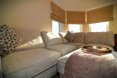 a living room with a couch and a table at Signature - Cross House in Lanark