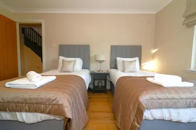 a hotel room with two beds with towels on them at Signature - Cross House in Lanark