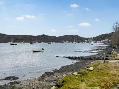 a large body of water with boats in it at Ardtornish Apartment in Tayvallich