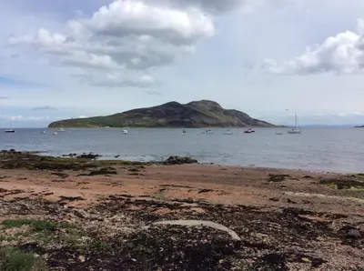 a small island in the ocean with boats in the water at Stonewater House Vegan Bed and Breakfast in Lamlash