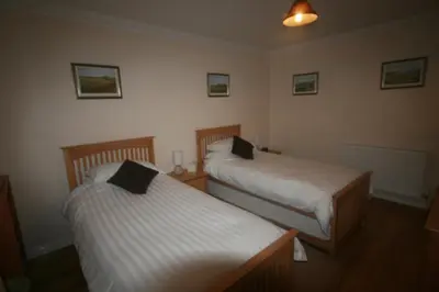 a room with two beds in a room at Stonewater House Vegan Bed and Breakfast in Lamlash