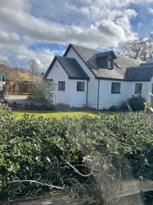a large white house with a black roof at The Roost in Appin
