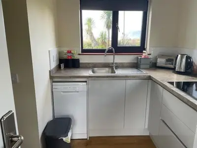 a kitchen with a sink and a window at The Roost in Appin