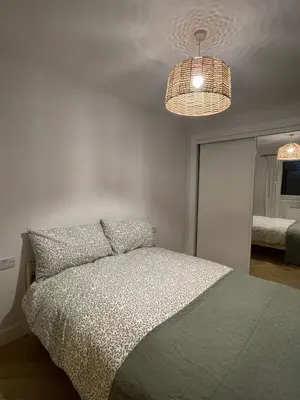 a bedroom with a bed with two pillows and two lights at 2 Bed on the Glasgow Green in Glasgow