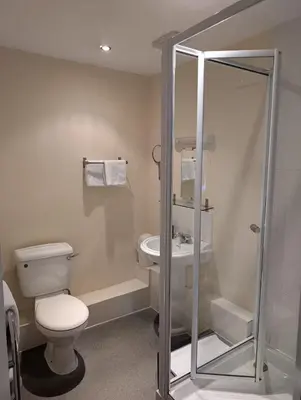 a bathroom with a toilet and a sink at Gordon Arms Hotel in West Linton