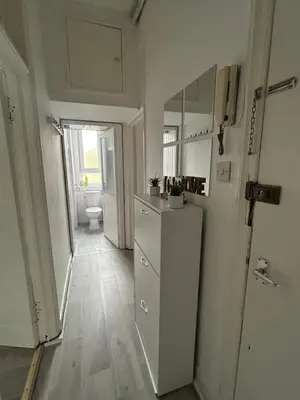 a kitchen with a refrigerator and a toilet in a room at Bright bedroom with king side bed and share bathroom in Edinburgh