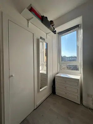 an empty room with a door and a window at Bright bedroom with king side bed and share bathroom in Edinburgh