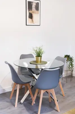 a dining room with a glass table and four chairs at Vacant Nests The Milton Dunfermline Parking in Dunfermline