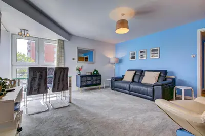 a blue living room with a couch and chairs at River Ayr View-Coorie Doon Stays in Ayr