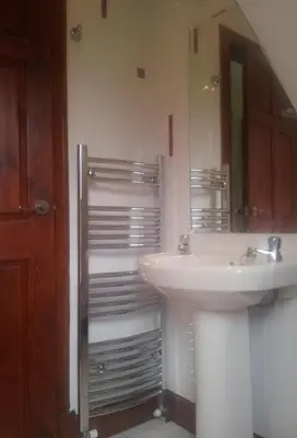 a bathroom with a sink and a mirror at The Snug a cosy, quirky detached cottage with sea views in Innellan