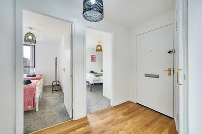 a hallway with a door leading to a living room at 2BR Flat with Free Parking in Central Location in Glasgow