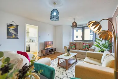 a living room with couches and a tv at 2BR Flat with Free Parking in Central Location in Glasgow