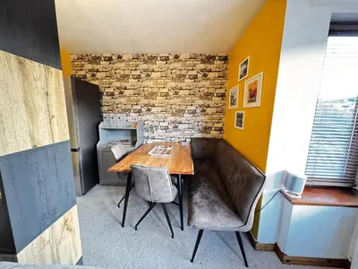 a dining room with a wooden table and chairs at The Maltings Retreat in Inverkeithing