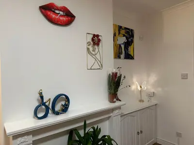 a room with a shelf with red lips on the wall at Private main door Two Bedrooms Apartment in Edinburgh