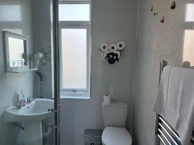 a bathroom with a toilet and a sink and a window at Private main door Two Bedrooms Apartment in Edinburgh