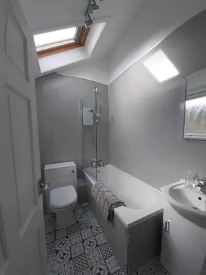 a white bathroom with a sink and a toilet at Coach House Cottage a cosy, detached hideaway with garden, nr the sea in Innellan