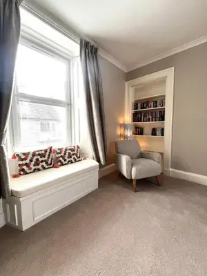 a living room with a window and a chair at Two Bedroom Apartment in Bridge of Allan in Bridge of Allan