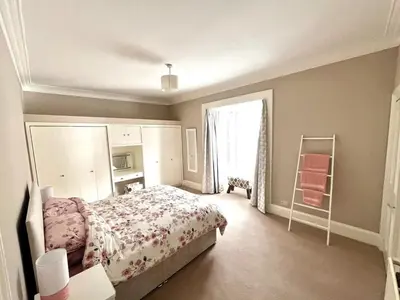 a bedroom with a bed and a window at Two Bedroom Apartment in Bridge of Allan in Bridge of Allan